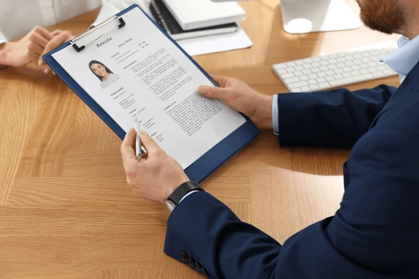 Hiring manager reviewing application at desk